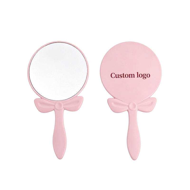 OEM/ODM Bow-knot Round Hand Mirror from Kaifam Manufacturing. Custom logo, Pantone colors, MOQ 100pcs, 15-day lead time. Request a free quote.